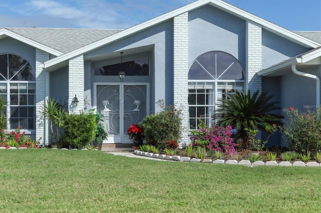 doorway to property with a lawn