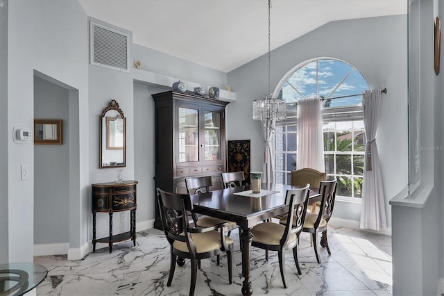 dining space with lofted ceiling and a chandelier