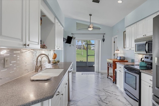 kitchen featuring sink, white cabinetry, tasteful backsplash, and appliances with stainless steel finishes