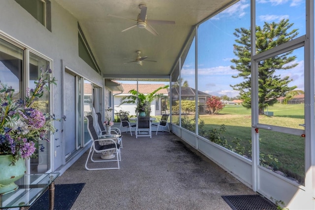 unfurnished sunroom with lofted ceiling and ceiling fan