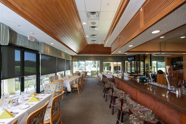 dining room with carpet floors and wood ceiling