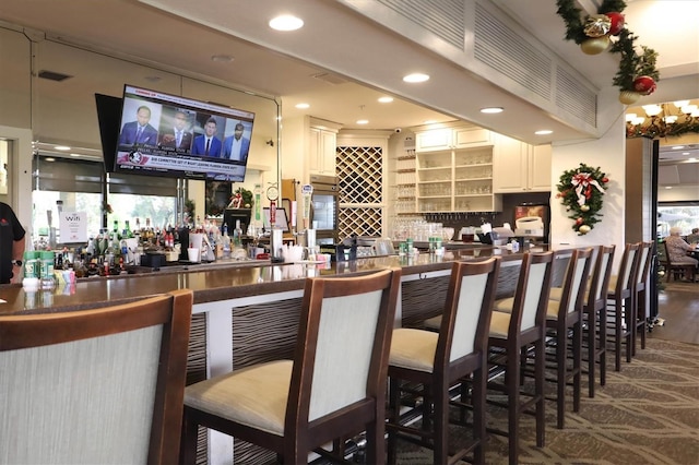 bar featuring white cabinetry and backsplash