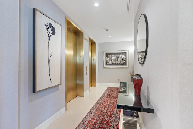 corridor with light tile patterned floors and elevator