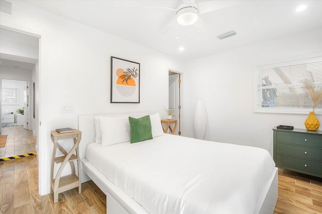 bedroom with light wood-type flooring and ceiling fan