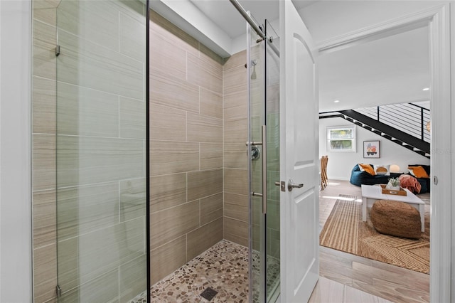 bathroom featuring a shower with shower door