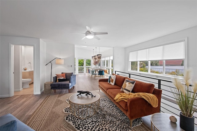 living room with ceiling fan and light hardwood / wood-style flooring