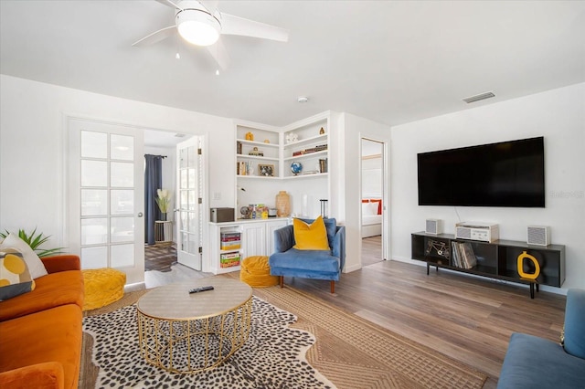 living room with ceiling fan and hardwood / wood-style flooring