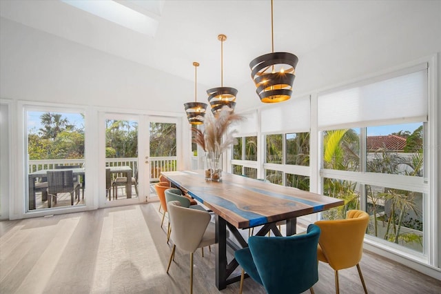 sunroom featuring lofted ceiling, french doors, a healthy amount of sunlight, and a notable chandelier