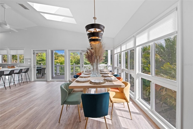 sunroom / solarium with lofted ceiling with skylight and ceiling fan