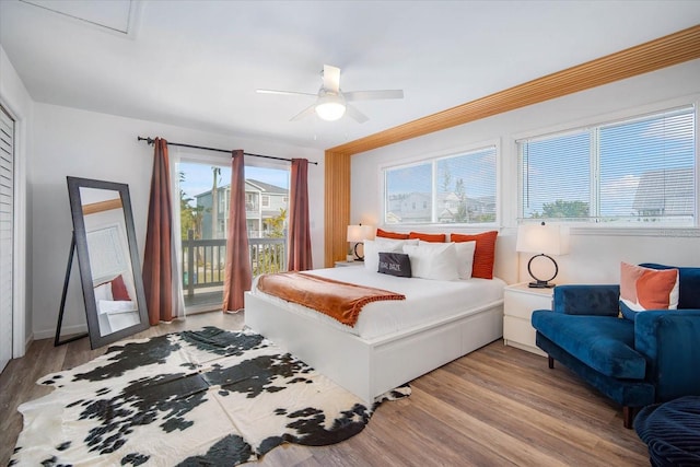 bedroom featuring ceiling fan, light hardwood / wood-style floors, and access to outside