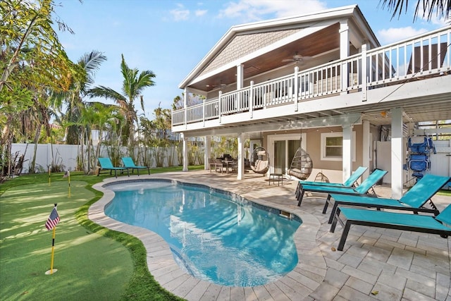 view of swimming pool featuring ceiling fan and a patio area