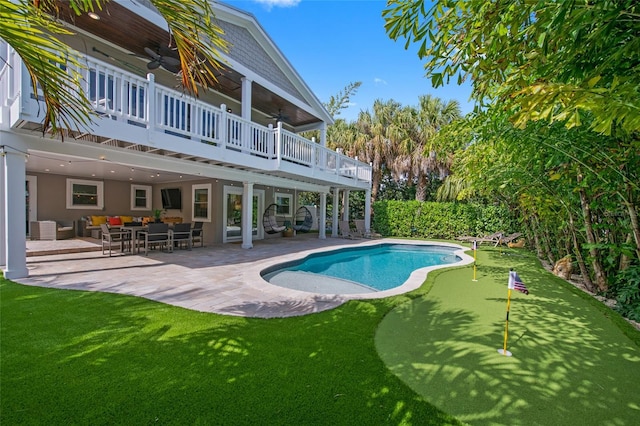 view of pool with a deck, a patio area, ceiling fan, and an outdoor hangout area