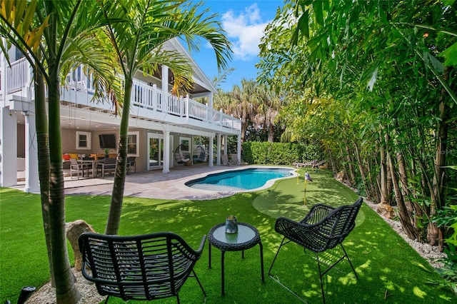 view of pool featuring a lawn, an outdoor hangout area, and a patio