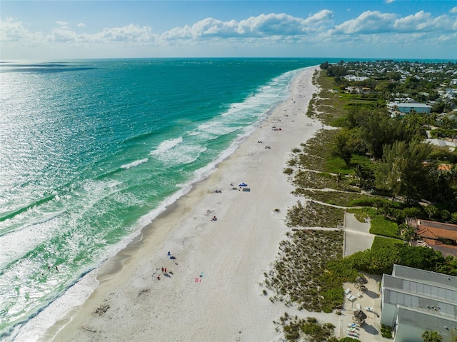 birds eye view of property featuring a beach view and a water view