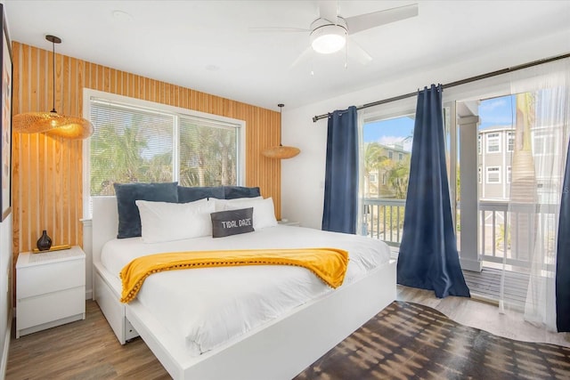 203 72nd St, Holmes Beach, FL 34217 - bedroom featuring access to outside, multiple windows, a ceiling fan, and wood finished floors