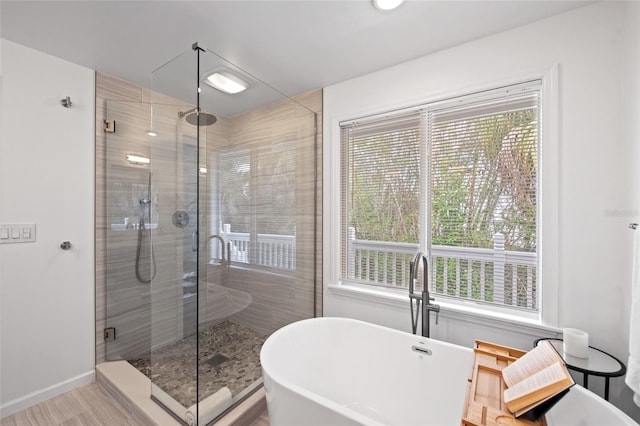 203 72nd St, Holmes Beach, FL 34217 - full bath featuring baseboards, a soaking tub, and a stall shower
