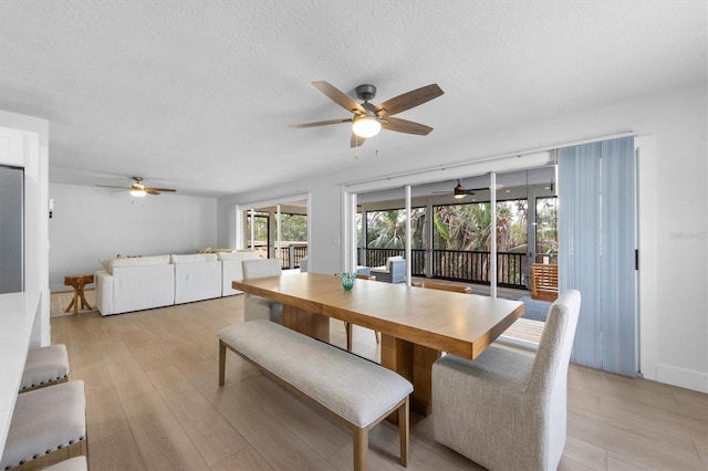 dining room featuring light hardwood / wood-style floors and a textured ceiling