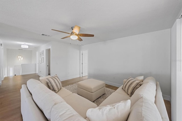 living room featuring hardwood / wood-style flooring and ceiling fan