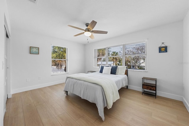 bedroom with ceiling fan, a closet, and light wood-type flooring