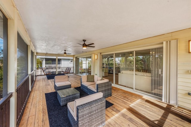 deck featuring outdoor lounge area and ceiling fan