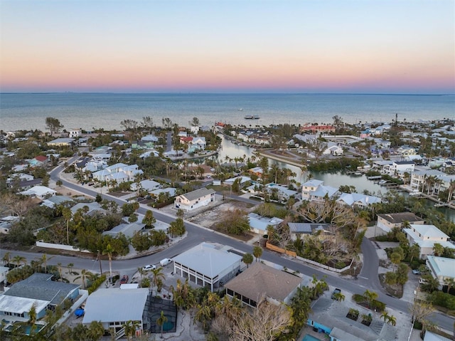 aerial view at dusk with a water view