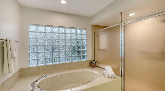 bathroom featuring shower with separate bathtub