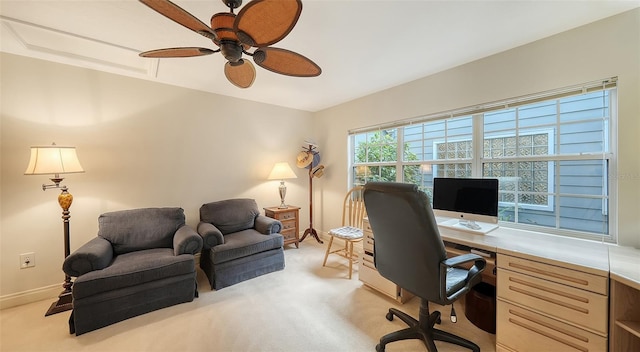 carpeted office space featuring ceiling fan