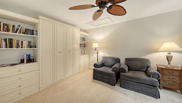 living area featuring ceiling fan and light colored carpet