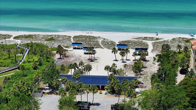 birds eye view of property with a water view and a view of the beach