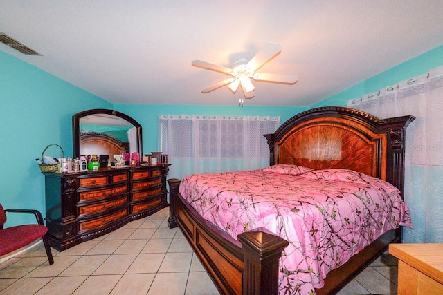 tiled bedroom featuring ceiling fan