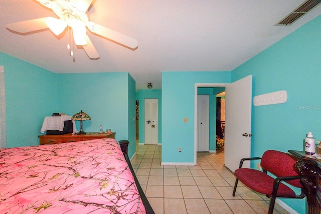 bedroom with ceiling fan and light tile patterned floors