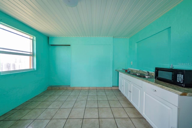 kitchen featuring sink and white cabinetry