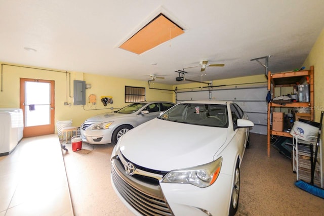 garage with electric panel, a garage door opener, washer / clothes dryer, and ceiling fan