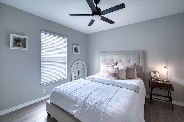 bedroom with ceiling fan and dark hardwood / wood-style floors