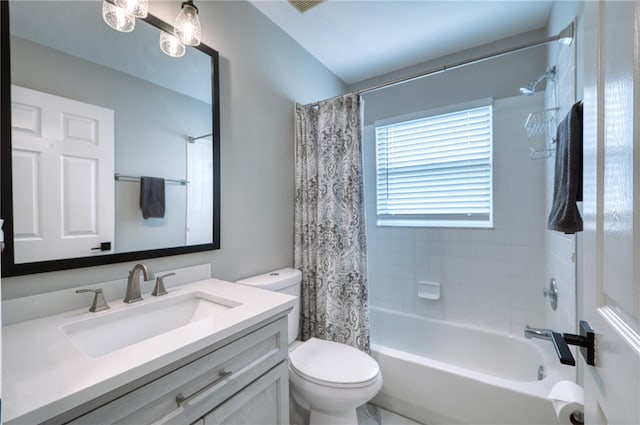 full bathroom featuring toilet, vanity, and shower / bathtub combination with curtain