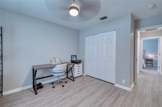 home office with ceiling fan and light hardwood / wood-style floors