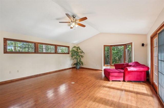 living area featuring light hardwood / wood-style floors, lofted ceiling, and ceiling fan