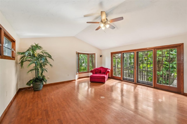 sitting room with lofted ceiling, light wood-type flooring, and ceiling fan