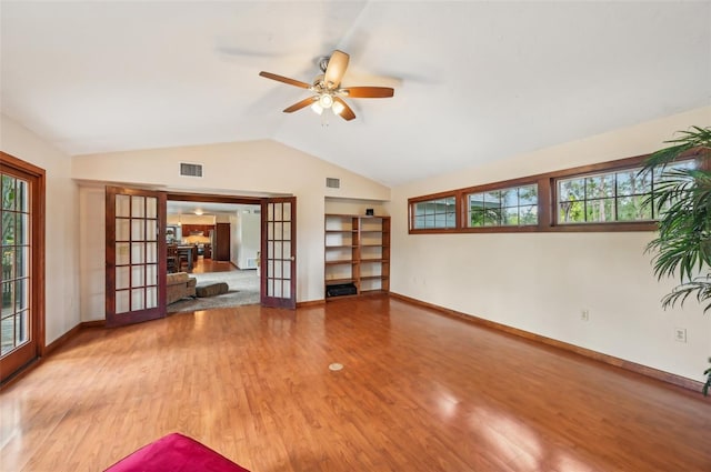 spare room with ceiling fan, french doors, vaulted ceiling, and light wood-type flooring