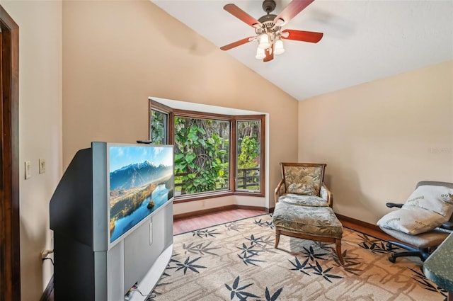 sitting room with ceiling fan, vaulted ceiling, and light hardwood / wood-style flooring