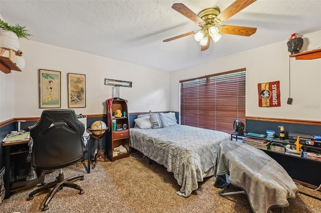 bedroom with ceiling fan, a textured ceiling, and carpet flooring