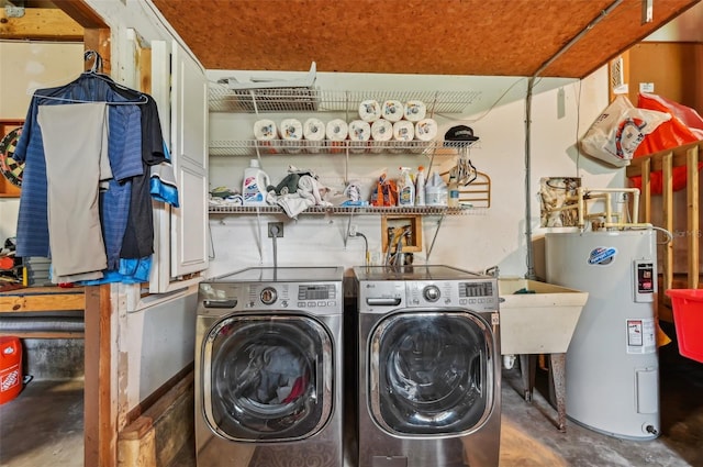 clothes washing area featuring water heater and separate washer and dryer