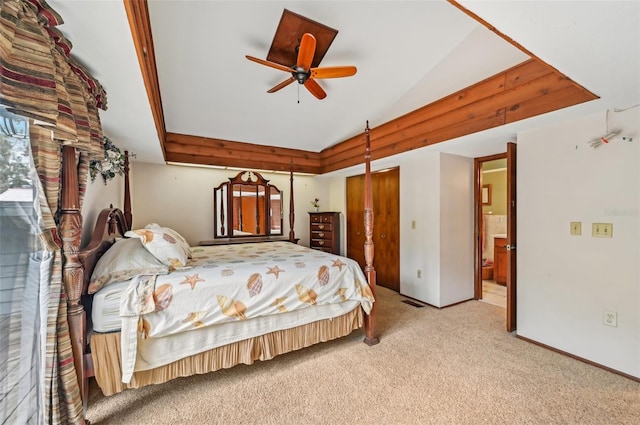 bedroom featuring ceiling fan, connected bathroom, and light carpet