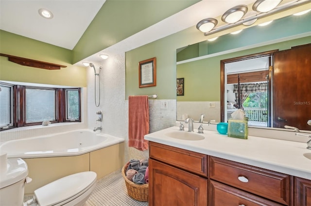 bathroom featuring vaulted ceiling, a wealth of natural light, tile patterned floors, and vanity