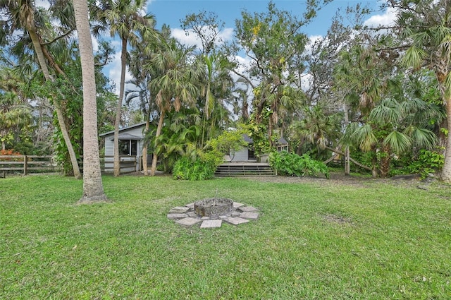 view of yard with an outdoor fire pit and a wooden deck