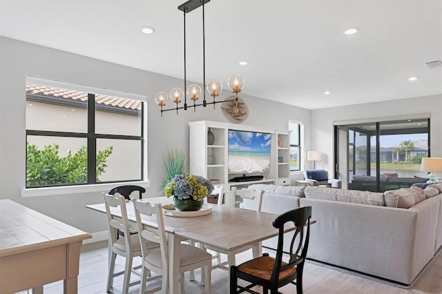 dining room featuring a chandelier and light hardwood / wood-style flooring