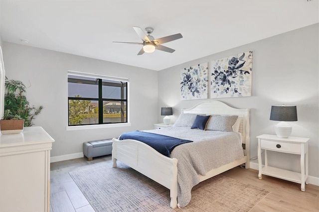 bedroom with hardwood / wood-style floors and ceiling fan