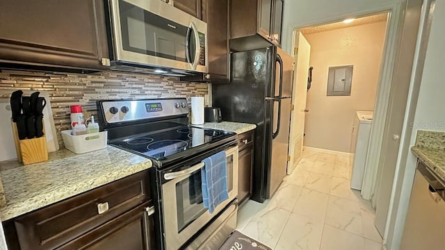 kitchen featuring dark brown cabinetry, stainless steel appliances, tasteful backsplash, and electric panel