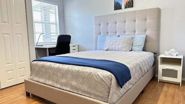 bedroom featuring hardwood / wood-style floors and a closet