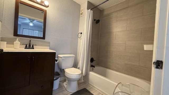 full bathroom featuring vanity, shower / tub combo, a textured ceiling, and toilet